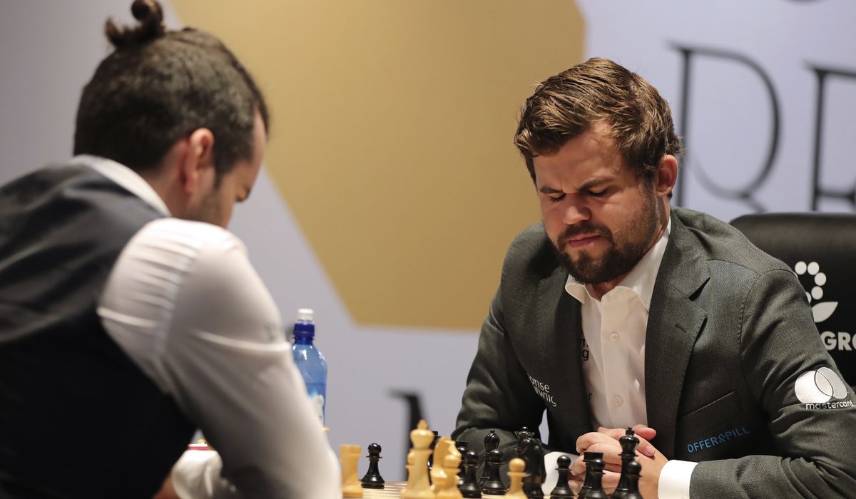 Champ Carlsen suffers, but holds draw to keep chess title fight tied